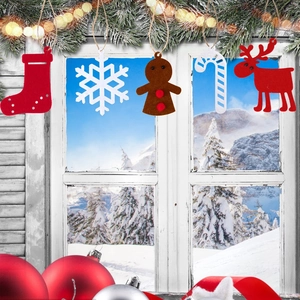 Detail of five handmade felt Christmas ornaments set featuring reindeer and snowflakes