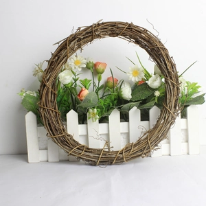 Natural woven rattan wreath base for Christmas DIY crafts on white wooden fence
