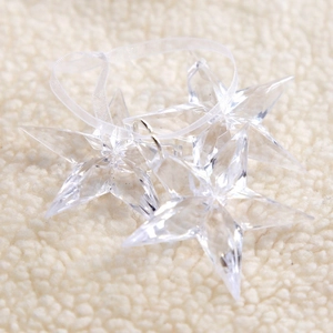 Set of three clear faceted acrylic star ornaments with white ribbons for Christmas tree