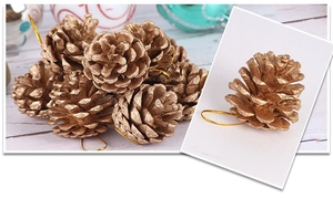 Detail of golden pine cone ornaments with metallic finish and gold hanging strings