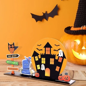 Detail of wooden Halloween desktop ornament featuring a black castle, R.I.P tombstone and ghost