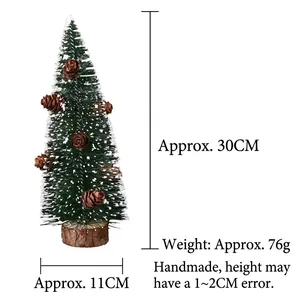 Detail of 30cm green frosted Christmas tree with natural pine cones and wooden base