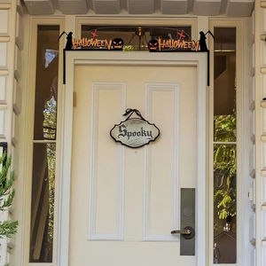 Black silhouette Halloween door frame decor with pumpkin motifs and Spooky hanging sign