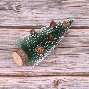 Mini green sisal Christmas tree with pine cones and snow frosting on wood base