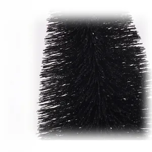 Macro shot of black frosted Christmas pine needles with delicate sparkling powder finish