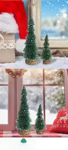 Detail of mini artificial pine trees with white snow effect on natural wooden bases