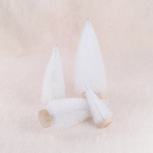 Set of 4 white bottle brush Christmas trees with wooden bases on soft cream fabric