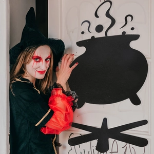 Detail of red and black witch costume with mesh pointy hat for Halloween party decor