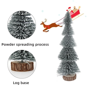 Miniature snow-flocked Christmas tree with natural log base for festive table decoration