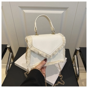 White fashion crossbody bag with fringe trim and golden chain strap detail