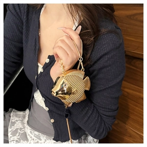 Artistic gold fish-shaped evening clutch bag with intricate scale texture and chain strap