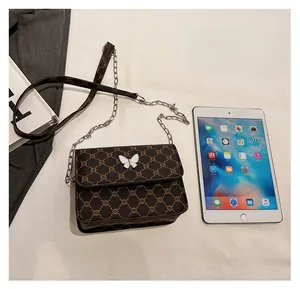 Detail view of a vintage monogram chain bag showing its size compared to an iPad