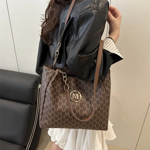 Brown monogram tote bag with gold M-logo and leather chain strap for women's fashion