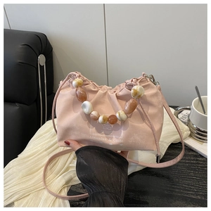 Pink drawstring bucket bag featuring decorative agate-textured bead handle detail