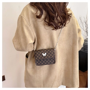 Brown mini crossbody bag with vintage geometric patterns and silver butterfly buckle