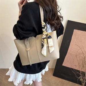Minimalist beige leather tote bag with stylish decorative scarf for women's daily commute