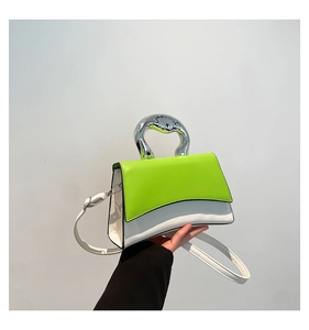 Detail of the unique fluorescent green and white color block bag with a silver metal handle