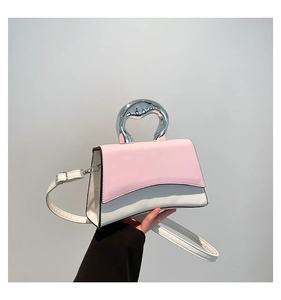Detail of pink and white square bag with unique liquid metal handle and curved base