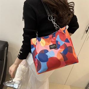 Colorful geometric pattern underarm bag with metal chain strap and minimalist design