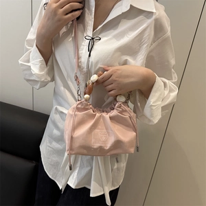 Pink drawstring bucket bag with pearl beaded handle and logo print for women