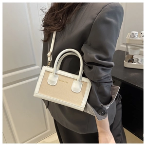 Model showcasing a small white leather and fabric crossbody bag with Anello 1986 branding