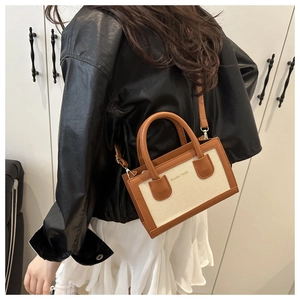 Detailed back view of a retro color-block canvas crossbody bag with brown leather trim