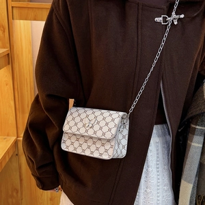 Mini square crossbody bag with vintage monogram and silver butterfly clasp on wool coat