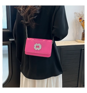 Modern hot pink crossbody bag with a crystal buckle shown from a back view