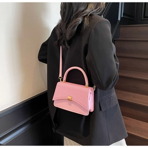 Détail du sac à bandoulière rose avec double texture et boucle en métal doré