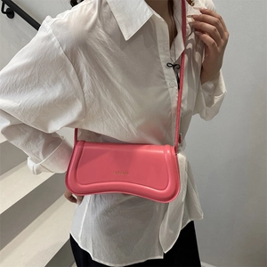 Chic wave-shaped pink leather baguette shoulder bag for women with gold logo lettering