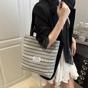 Modern striped canvas tote bag with geometric patterns for stylish daily commuting