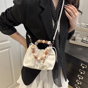 White ruched drawstring bucket bag with beaded handle and shoulder strap for women