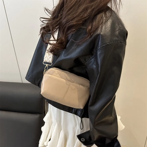 Beige small square crossbody bag with textured woven strap and gold hardware accents