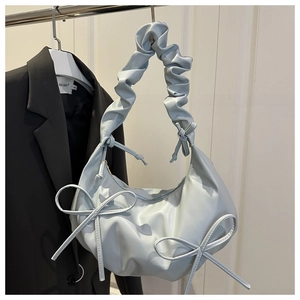 Light blue pleated tote bag detail with bow accents and ruffled shoulder strap