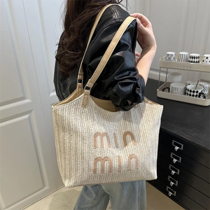 Beige woven tote bag with 'min min' embroidery and brown leather handles for women