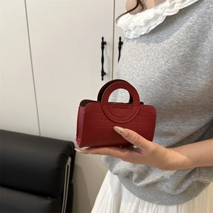 Mini crocodile pattern handbag in bright red with round handles for a retro look