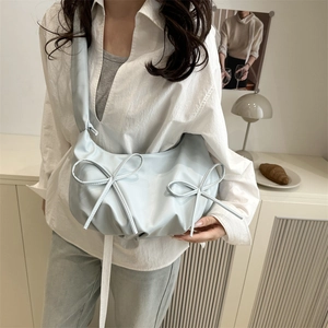 Light blue glossy underarm bag with large bows and pleated texture for fashion commute
