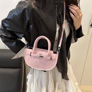 Chic pink semi-circular PU leather handbag with silver twist lock and crossbody strap