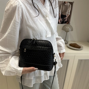 Retro black woven shell crossbody bag with adjustable shoulder strap and gold hardware