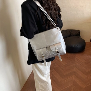 Metallic silver square tote bag for women featuring stylish buckle straps and slim handles