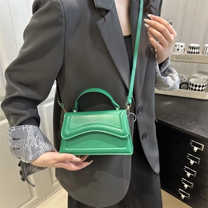 Fashionable bright green mini square crossbody bag with top handle and PU leather finish