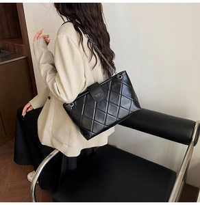 Classic quilted black faux leather shoulder bag with silver chain strap and metal lock