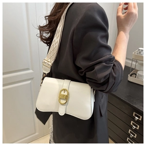 Detail of white square crossbody bag with patterned strap and golden oval buckle
