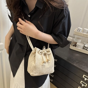 Chic woven bucket bag for women with beige V-pattern texture and drawstring closure