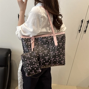Chic black tote bag with pink bow pattern and matching small pouch for women