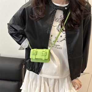 Chic neon green mini crossbody square bag with double buckles on a leather jacket model