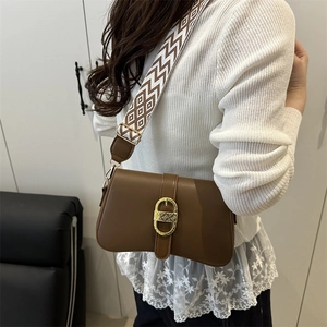 Fashionable brown crossbody bag with geometric woven strap and golden metal buckle