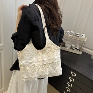Chic cream layered lace shoulder bag with tiered ruffles in a stylish interior setting