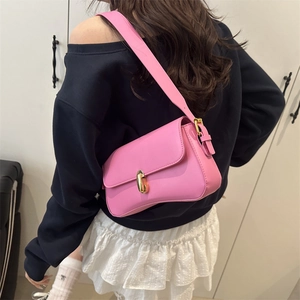 Fashionable hot pink leather underarm bag for women with wide shoulder strap and gold buckle