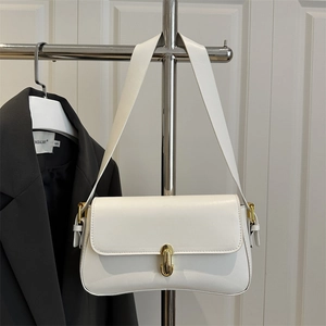 Minimalist white leather underarm bag with gold clasp shown on a stylish hanger